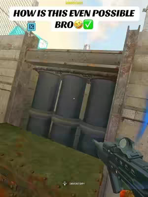 The cover image presents a first-person perspective from a video game, likely a shooter. The view shows a close-up of an angled wall with three cylindrical structures built into it and a gun pointed toward the right. Digital text overlays are present, in white.