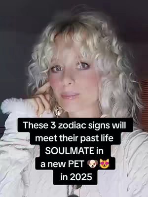 A selfie-style image of a woman with curly blonde hair looking towards the viewer. She is wearing a white sweater. Overlaid on the image is a black rectangular box containing text. The text says, "These 3 zodiac signs will meet their past life SOULMATE in a new PET" followed by a dog and cat emoji, "in 2025".