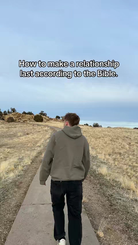 A man walks away from the camera along a paved path through a field of dry grass. The sky is overcast. Overlay text at the top reads, 'How to make a relationship last according to the Bible.'
