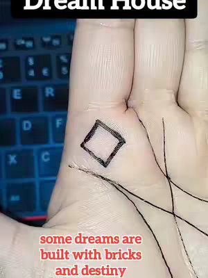 The image shows a close-up of a person's palm with palmistry lines. A square is drawn on the palm, and text overlays read 'Dream House' and 'some dreams are built with bricks and destiny'. The background behind the palm shows a blurry view of a keyboard.