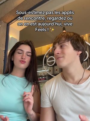 A cover image featuring a young man and woman in a casual setting with overlaid text. The woman, on the left, has dark hair and is wearing a light turquoise top, giving a small closed-mouth kiss to the camera. The man, on the right, has short brown hair and is wearing a white t-shirt. They're standing in front of what appears to be a window or open doorway, with out-of-focus elements that suggest an interior setting, likely a cafe or restaurant. The overall composition feels relaxed and candid.