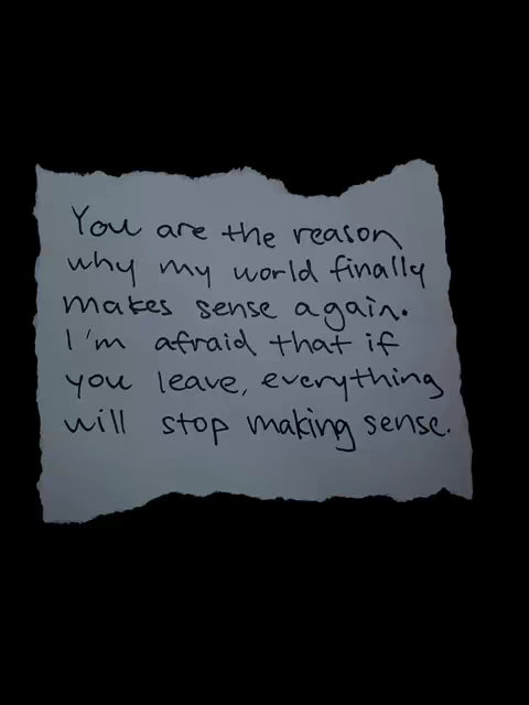 A black background with a piece of torn, white paper in the center. Handwritten text in black ink is on the paper. The text is a romantic message.