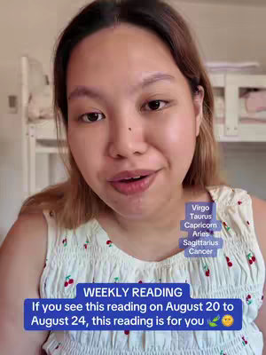 A selfie-style shot with a woman looking directly at the camera, smiling faintly. A blue rectangle with white text indicating "WEEKLY READING" at the top and the timeframe of the reading at the bottom. To the right is a vertical list of zodiac signs. The background suggests a light-filled interior with some white furniture or structures.