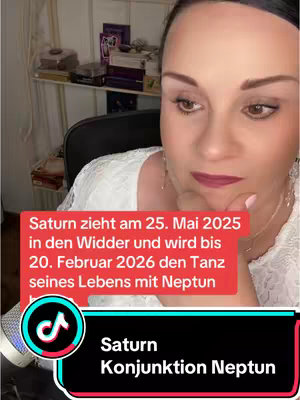 The cover image shows a woman looking down and to the side with a serious expression. Text overlays are present, including a red banner at the bottom with white text stating 'Saturn Konjunktion Neptun'. Above this is a longer, red text box with white text providing astrological information. The background is slightly blurry, suggesting the video is inside a room.