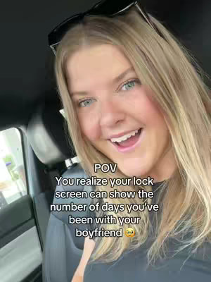 The cover image shows a young woman smiling towards the camera with sunglasses resting above her forehead. Text is overlaid describing a question about a lock screen feature. The woman appears to be in a car with the interior visible in the background.