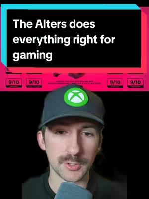 A selfie-style video cover featuring a man in a black shirt and a grey and green ballcap. He fills most of the frame with the upper torso with his face taking up a significant portion. Above him is a partially visible graphic with the text “The Alters does everything right for gaming” in white against a black background with teal and pink accents. Underneath the text there are rating boxes with review scores. The background is a plain black.