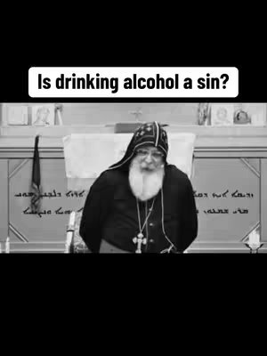 A black and white image featuring a man with a long white beard wearing a dark robe and a black hat. Above him is white text in a black rectangle, with the text: "Is drinking alcohol a sin?"