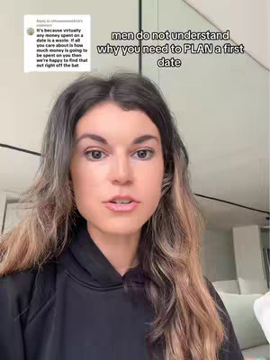 A woman with long, dark hair is looking directly at the camera. Above and behind her, text overlays appear, and there's a partial view of a light-colored wall.