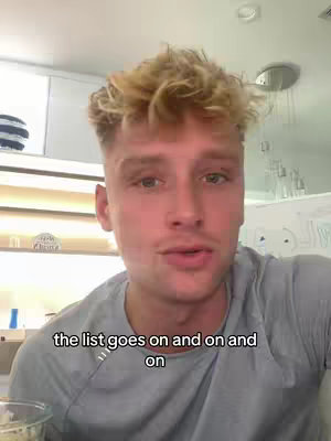 A man with short, blond hair and a gray shirt looks directly at the camera. Text at the bottom of the screen reads, "the list goes on and on and on." The background features a white ceiling and a partially visible cabinet, suggesting an indoor setting.