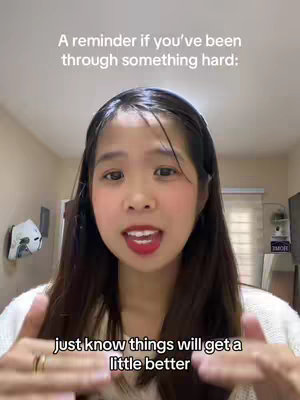 A young woman with dark hair and red lipstick is centered in the frame, with text overlays above and below her. She is gesturing with both hands, and the background appears to be a simple, well-lit room.
