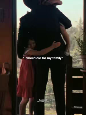 A person in a dark suit embraces a young girl in a red dress. They stand near a bright window. A text overlay at the bottom says, "I would die for my family."