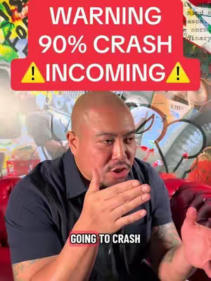 A bald man with a dark shirt is speaking while gesturing with his hands. Above the man is a red banner with white text that says, "WARNING 90% CRASH INCOMING" with an exclamation mark on each side. Below the man is a pink banner with the words "GOING TO CRASH". Behind him is a colorful wall with some graffiti.
