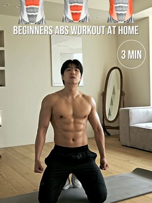 A man with a muscular physique kneels on a gray mat in a well-lit room, looking towards the camera. He is shirtless, wearing black shorts and white athletic shoes. In the background, there's a mirror, a gray sofa, and what appears to be a door or large window. The cover art promotes an at-home abs workout. The image is framed with text overlays for the video's title and duration.