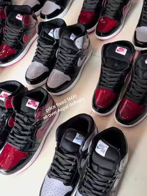 An overhead shot features multiple pairs of high-top sneakers, predominantly in black, red, and grey. The sneakers are arranged in a close, almost overlapping, pattern, with visible laces and logos. The background is a light-colored surface, perhaps a table or floor. Text overlay indicates a price and delivery information as well.