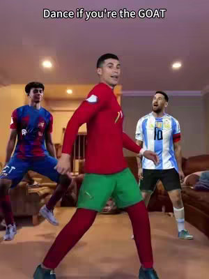The image shows three soccer players, presumably Cristiano Ronaldo, Lionel Messi, and another player, in a domestic setting. Cristiano Ronaldo is in the center, wearing a Portugal jersey, striking a dance pose. Messi is off to the right in an Argentina jersey, with the other player positioned on the left. The background includes a living room setup, with light-colored walls, a neutral-toned floor and brown couch and side table visible. The lighting looks moderately bright, suggesting an indoor shot.
