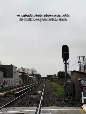 The cover image shows a railway track receding into the distance under an overcast sky. On the right side, there's a signal and utility pole, and hints of buildings and graffiti flank the tracks. Text overlayed on the sky provides context.