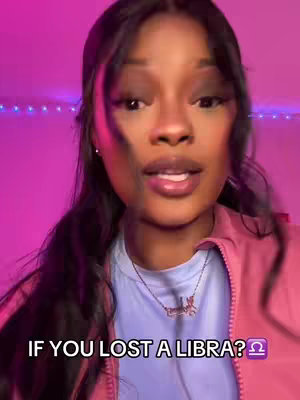A woman with long dark hair and a pink jacket is centered in the frame. Text overlay reads "IF YOU LOST A LIBRA?" The background is brightly lit with a pink hue.