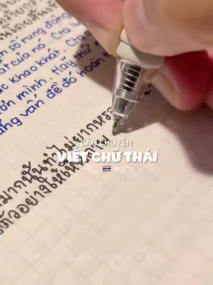 A close-up shot of a hand writing notes with a pen on lined paper. The background is blurred, focusing on the writing process. Overlay text provides additional context.