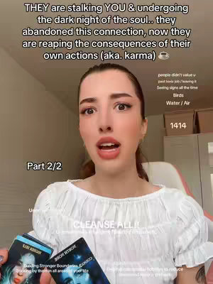 A woman with long, dark hair and makeup is centered in the frame, looking directly at the camera with an open mouth as if speaking. Text overlays appear at the top and bottom, and she holds tarot cards in her hands.