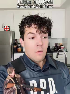 The cover image features a man in a kitchen setting, wearing a dark blue R.P.D. vest. He has short, dark, curly hair and a slightly surprised expression. A small figure of Leon Kennedy holding a shotgun is positioned near his shoulder. The background includes white cabinets, a stainless steel refrigerator, and various kitchen items. Text overlay is present at the top of the image.