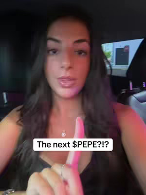 A woman in a car is looking at the camera with a serious expression. The foreground features her hand pointing upwards with a pink fingernail. A text overlay reads 'The next $PEPE?!?'