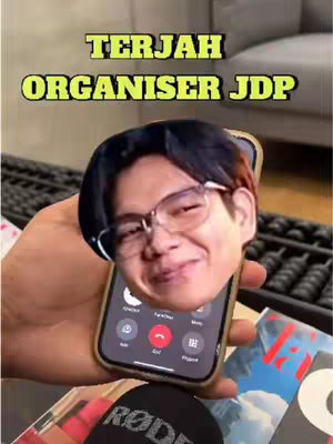A selfie-style shot shows a person's head as a cutout, superimposed on a phone. The image is held in a hand, and the phone screen displays active call buttons. The background shows a dimly lit interior with various objects and a surface.