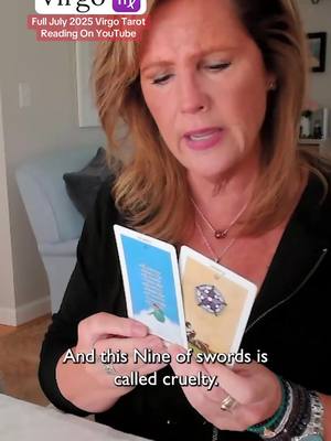 A woman with blonde hair is holding two tarot cards, with text overlays. She's wearing a dark top and jewelry. The cards are different colors, and the background is a blurry shot of a room. Text overlays include time/date indicators and additional text about her readings.