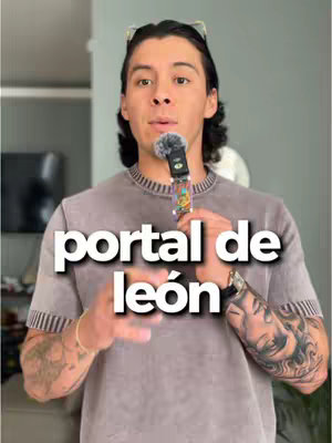 A man with dark hair and glasses is holding a microphone in his right hand. Overlaid on top of the man is the text "portal de león". The man is wearing a t-shirt with an intricate tattoo on his right arm. The background seems to be a blurred greyish-white color.