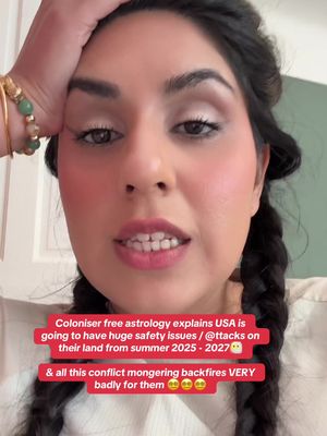 The cover image is a selfie-style shot featuring a woman from the chest up, with the focus on her face. She has dark hair styled in braids. She has a hand on her forehead, and her expression is one of concern or contemplation. In the foreground, a text overlay in a pink rectangle provides additional information. The woman is fair-skinned with visible makeup, including blush on her cheeks and a neutral eye shadow and lipstick. The background appears plain and out of focus, with hints of a wall.
