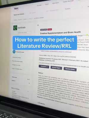 A vertical shot displays a computer monitor. The monitor is displaying a web page with text in the center, a blue rounded rectangle overlay text on top, and a visible keyboard below . The text overlay reads, "How to write the perfect Literature Review/RRL."