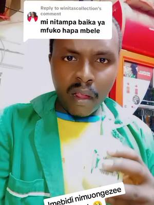 A man with a mustache is shown in a close-up, looking slightly to the side with his tongue out. He's wearing a green jacket over a yellow and blue shirt. Text overlays are present in the image.