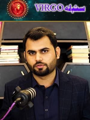 A man is the focus with a microphone in his hand, looking towards the camera. Behind him are bookshelves and in the top left corner is a zodiac sign. The text overlayed displays 'VIRGO' in a dark green gradient color.