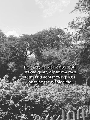 A black and white photo of a forest scene with text overlayed. The foreground features a fence, bushes and foliage, while the midground is filled with trees and the background shows the sky. The text is in a black font and overlaid in the midground.