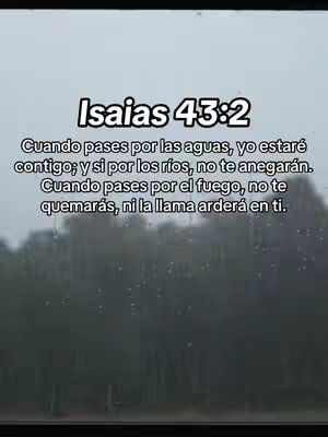 A vertically-oriented image captured through a window with water droplets visible, suggesting rainfall or a misty environment. The blurred background hints at trees or foliage. Overlayed on the image is a text section containing a Bible verse from Isaiah 43:2, written in Spanish, with the title 'Isaias 43:2' in a bold, clean font.