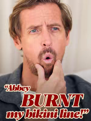 The cover image features a close-up of a man's face with a slightly bewildered expression. He has short, light brown hair, blue eyes, and a trimmed beard. He's wearing a grey shirt. Overlayed on the image is stylized text in a bold, red font, which reads "Abbey BURNT my bikini line!" The background is a soft, blurred cream color.