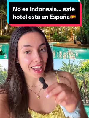 A woman with long brown hair stands in front of a turquoise-colored pool. She is holding a microphone and smiling. Behind her is a hotel with palm trees. The image has a bright and inviting aesthetic.