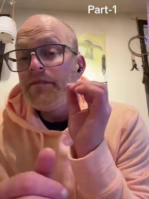 A man with glasses and a bald head, wearing a peach hoodie, is looking towards the camera and making a hand gesture. The text "Part-1" is displayed in the upper-right corner.