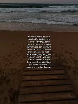 The image shows a serene beach scene at dusk. The sky transitions from a light blue to a deeper shade, and the ocean waves gently roll towards the shore. On the beach, there's a wooden walkway leading towards the water. Overlayed on the scene is a block of text, conveying a message about the impact of words and kindness. The overall composition evokes a feeling of reflection and introspection.