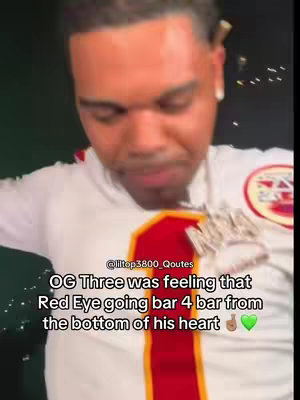 The image displays a close-up of a man with light skin. He is wearing a white shirt with a red and gold design, a thick silver chain, and has a somewhat pained expression. Text overlays on the image provide additional context.