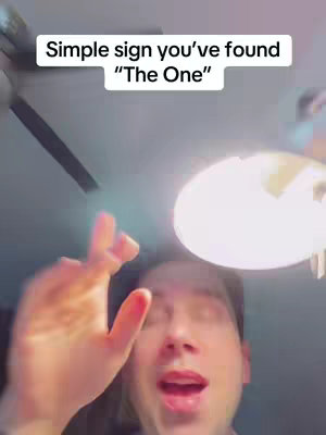 A man is shown from the chest up with a bright light overhead, his hand is moving in the air, and text is displayed at the top.