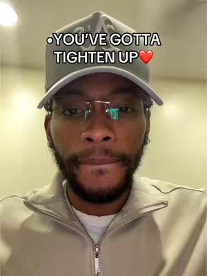 A man with a beard and glasses wears a baseball cap while looking somberly at the camera. The image is well-lit, featuring a neutral background, and a text overlay at the top that reads: “YOU’VE GOTTA TIGHTEN UP ❤️”. The composition is a close-up.