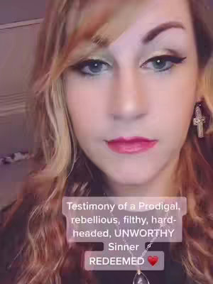 A close-up shot of a woman's face. She has fair skin, blonde hair, and is looking slightly off-center. Her makeup includes eyeshadow, eyeliner, and red lipstick. Overlayed on the image are text boxes with inspirational phrases, highlighting the theme of redemption.