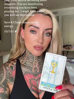 A blonde woman with visible tattoos on her neck and arm looks directly at the camera, holding a brightly colored tarot card. Text overlays the image, providing affirmations and encouragement.