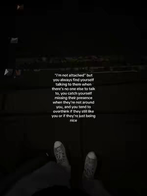 The cover image is a low-angle shot taken in a dim setting, possibly outdoors or in a dimly lit room. The perspective is from someone looking down at their own feet; worn, patterned canvas shoes are visible. The background is dark and blurry, with the suggestion of a street or pathway made of pavers. Centered on the image is a block of white centered text, formatted in a sans-serif font. The overall tone seems melancholic and introspective because of the text and the dim lighting.