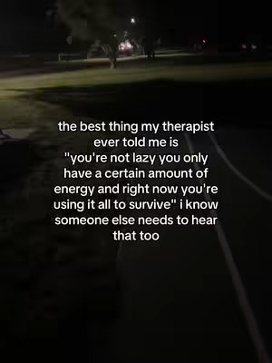 The image is a vertical shot taken at dusk or night, featuring a dark, blurred background suggestive of a street scene. At the bottom of the image, there is a section of a road and a grassy area with a few blurred lights in the distance. The image contains white text stacked in the center, which conveys words of encouragement and relates to the viewer's energy level. The composition is simple, focusing entirely on the text overlay.