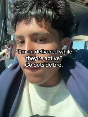 A person of color with dark hair and wearing a white shirt and blue jacket. The user is on a bus or similar vehicle with text overlayed on the image that is white.