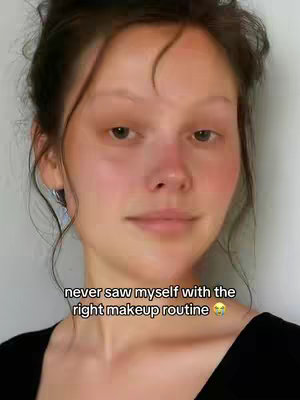 A selfie of a woman with her hair pulled back. overlaid text at the bottom states, "never saw myself with the right makeup routine".