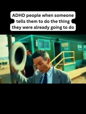 The cover image is from a scene of a man in a suit looking surprised while holding a hat, in a place with a small green building. A text overlay in a white box is displayed at the top of the image.