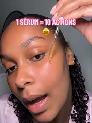 A close-up shot of a person's face focused on the right side of the face, showcasing the application of a serum with a dropper applicator. The person has fair skin with visible product application and a slight shine. A text overlay emphasizes the product's features. The composition uses soft lighting and high contrast to highlight skin texture. The background is blurred, which keeps the focus on the face. The hair is styled back, and the person's lips are slightly open.