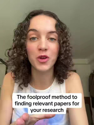 A woman with curly brown hair faces the camera, talking. The background is slightly blurred, with neutral tones. A text overlay at the bottom says, "The foolproof method to finding relevant papers for your research."